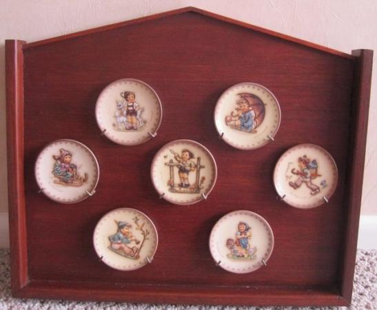 Image 1 of Seven small M J Hummel Plates and display case