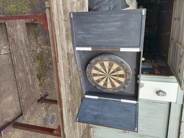 Preview of the first image of Dartboard in home-made wooden case..