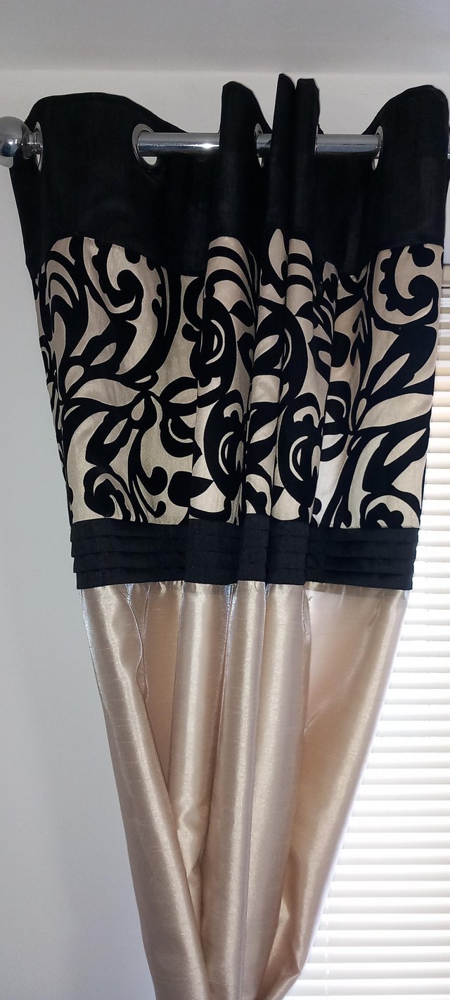 Preview of the first image of Black topped gold coloured lined curtains.