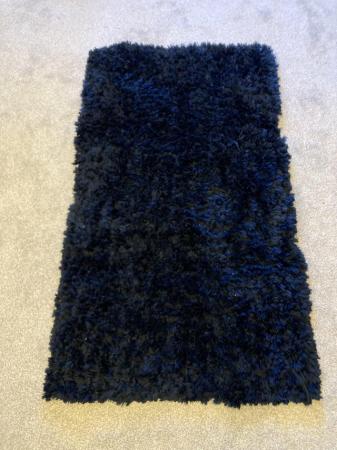 Image 1 of Dark blue rug for sale .