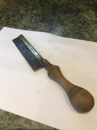 Image 1 of A carpenter’s vintage small hand saw with turned handle.