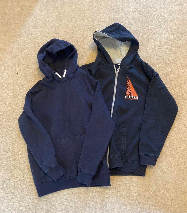 Preview of the first image of Boys hoodie x two. One Navy. One black. 11-12.