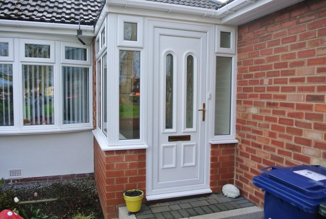 Preview of the first image of UPVC Front Door with frame, sill and decorative trim.