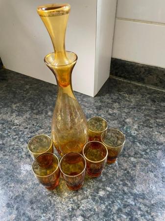 Image 1 of Decanter with six small glasses to match.
