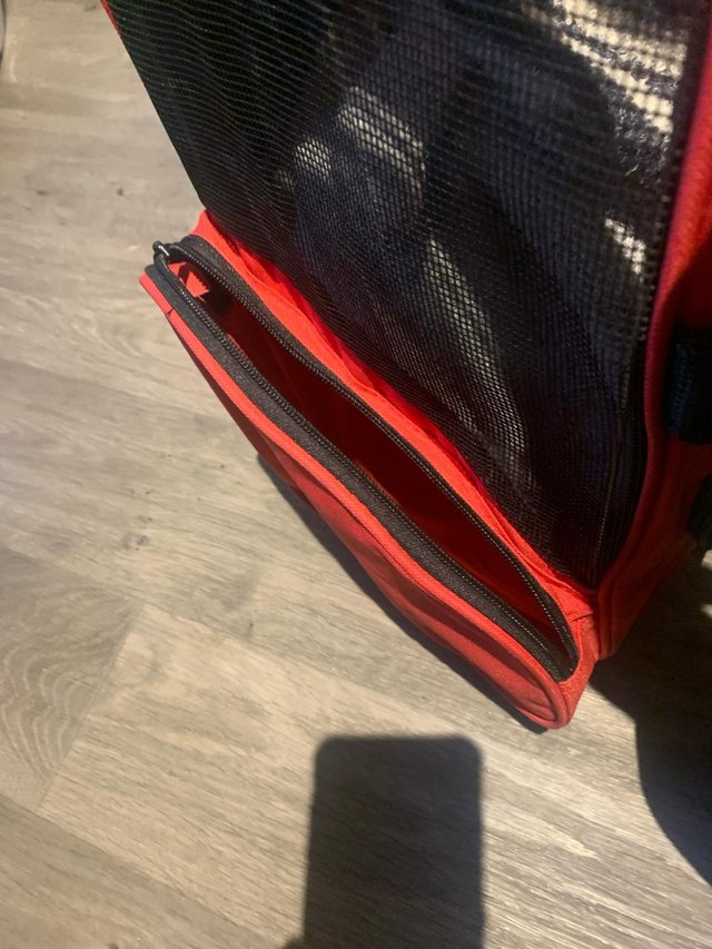 Preview of the first image of DOG CARRIER OR TROLLEY IN RED AND IS AS NEW CONDITION..