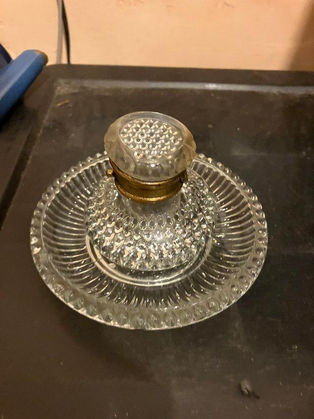 Preview of the first image of Cut glass inkwell with stand and brass rim.