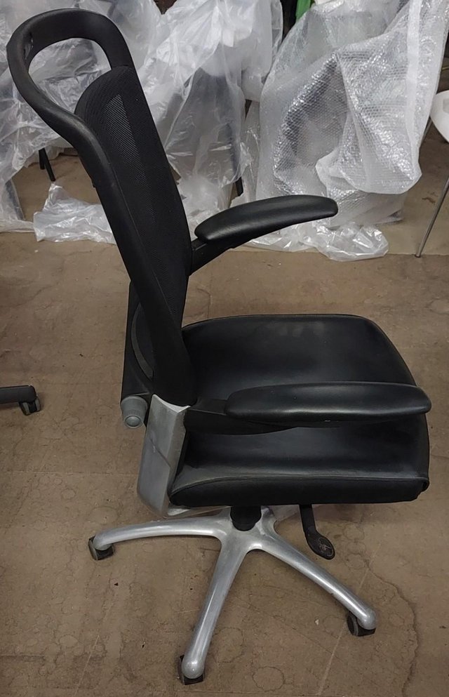 Preview of the first image of Black office chair with leather seat and netted back.