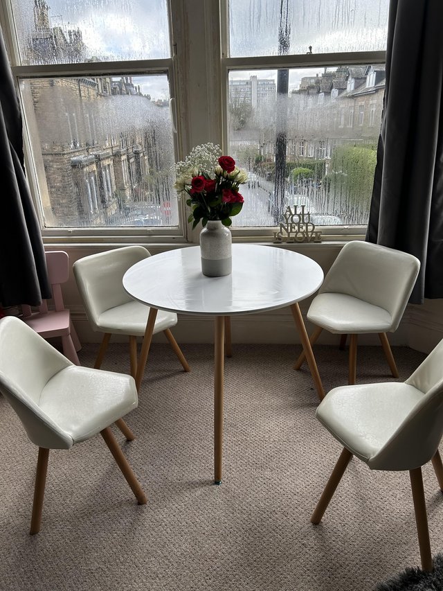 Preview of the first image of Round white table & four chairs.