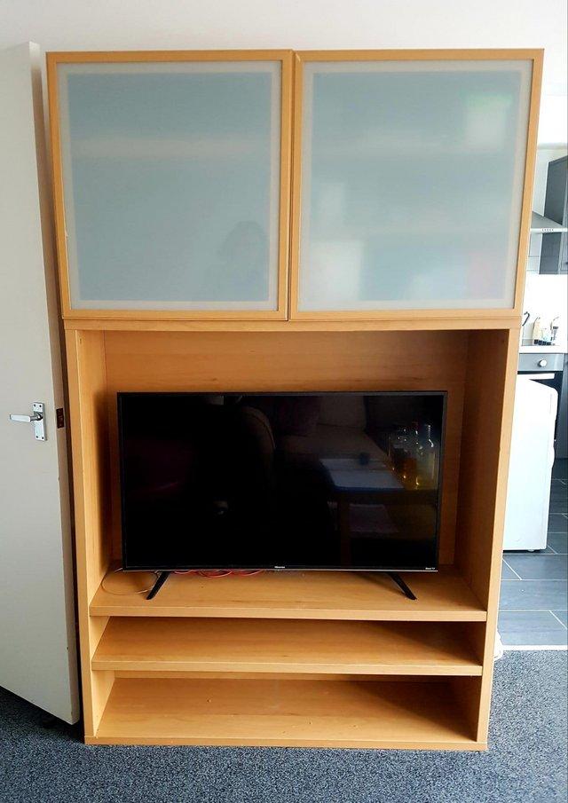 Preview of the first image of Striking IKEA TV and media storage unit with white glass doo.