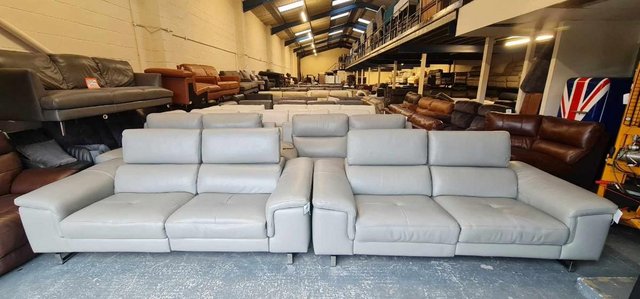 Preview of the first image of Italian Lucio grey leather electric pair of 3 seater sofas.