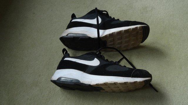 Preview of the first image of Nike Air sports shoes in black with suede leather panels.