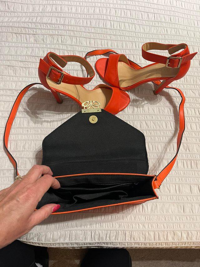 Preview of the first image of Orange 2 part stilettos & orange bag.
