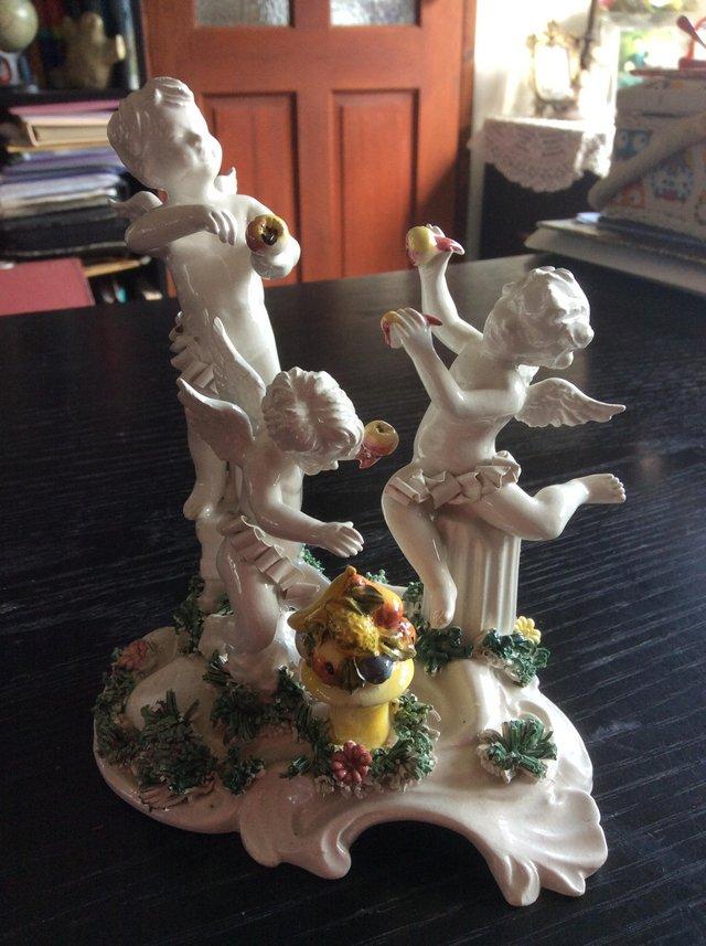 Preview of the first image of Fine porcelain ornament of three cupids.