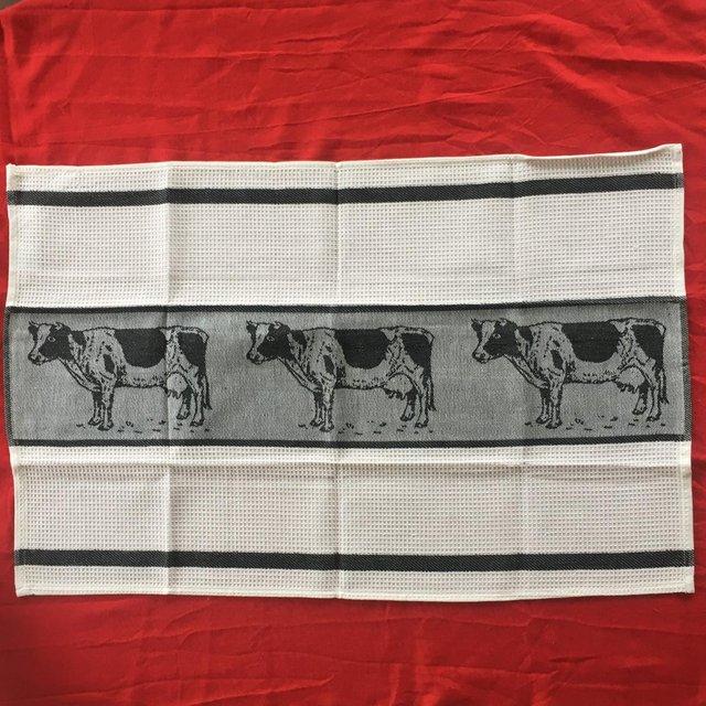 Preview of the first image of New tea towel, black & white cow design. 100% cotton..
