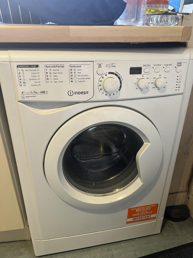 Preview of the first image of Indesit washing machine with instructions manual.
