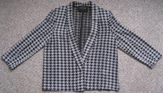 Preview of the first image of River Island black and white open weave jacket, size 12.