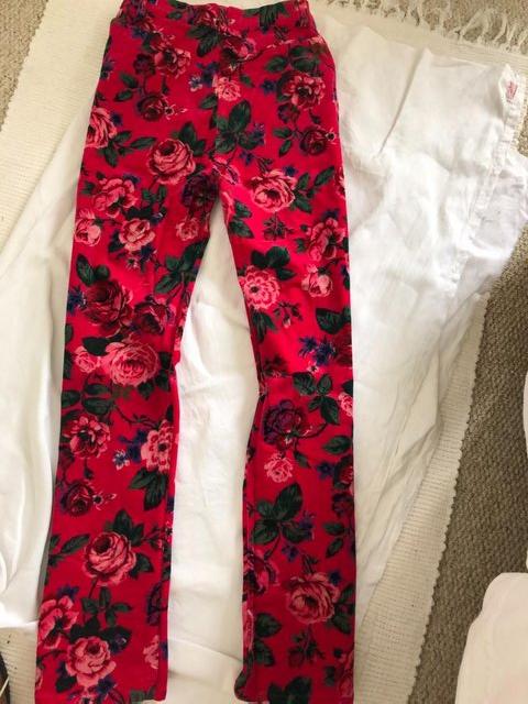 Preview of the first image of Unusual Stretch Floral trousers size 38 pink background.