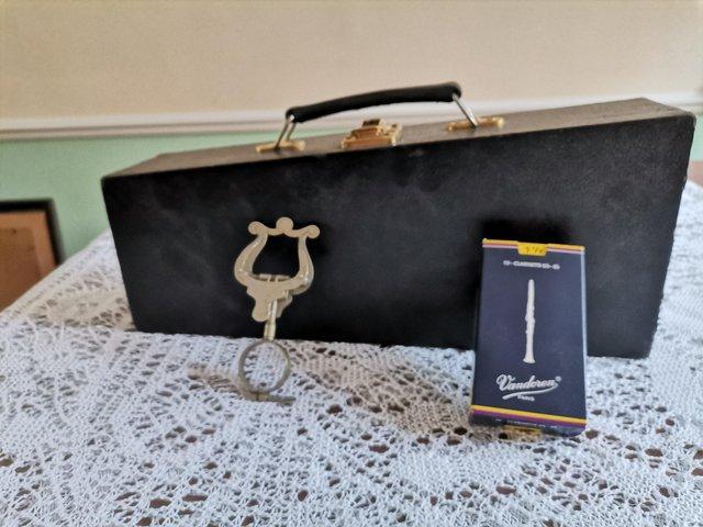 Preview of the first image of Clarinet case, music holder and reeds.
