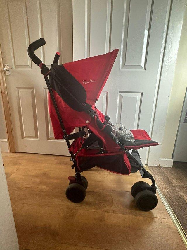 Preview of the first image of Silver Cross pop in red pushchair.