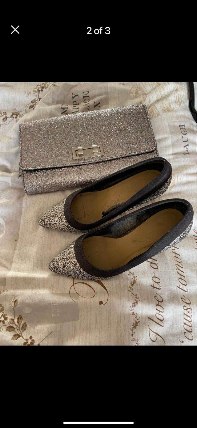 Preview of the first image of Silver sparkle clutch bag and shoes.