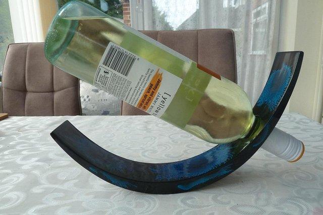 Preview of the first image of Attractive hand-crafted self-balancing bottle holder.