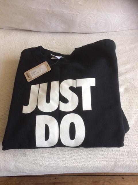 Preview of the first image of NEW NIKE BLACK SWEAT SHIRT STILL HAS LABELS ON ITEM.