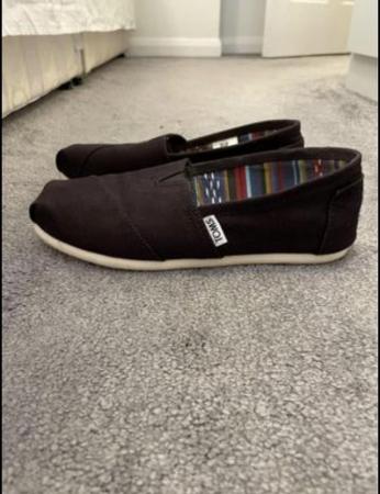 Image 2 of Toms canvas shoes in black.
