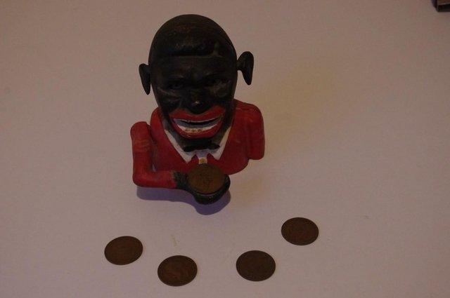 Preview of the first image of Jolly Sambo money box with pennies.