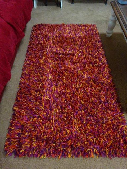 Preview of the first image of GORGEOUS DUNELM SHAGGY MAT/RUG-GOLD/REDS.