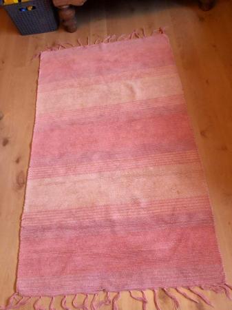 Image 1 of Medium sized orange rug in very good condition