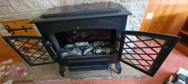 Image 2 of Black iron traditional looking electric fireplace with wood