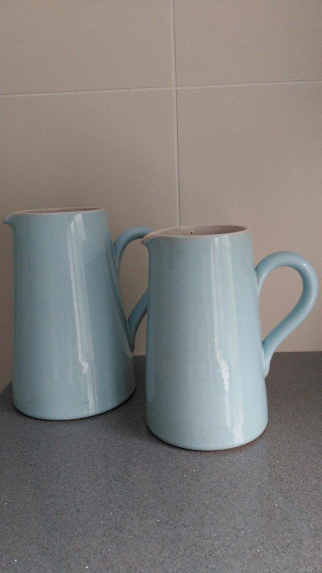 Preview of the first image of 2 VINTAGE LOVATTS PALE BLUE STONEWARE MILK / WATER JUGS.