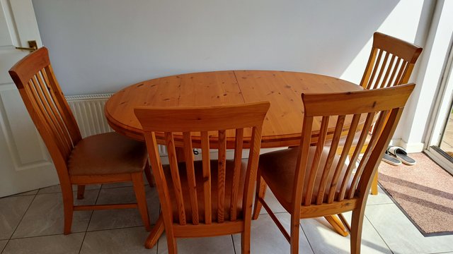 Preview of the first image of Wooden extendable dining room table and 6 chairs.