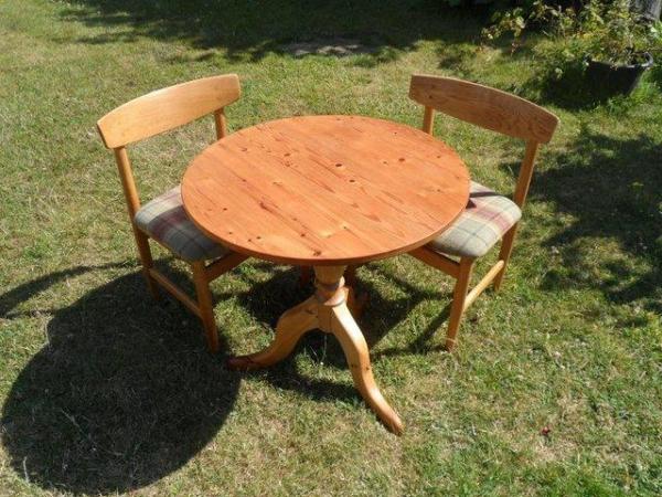 Image 1 of Small pine circular table with a pair of chairs.