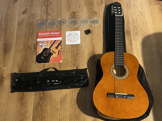 Preview of the first image of 6 String Classical Guitar With Clip On Tuner, Book and stand.