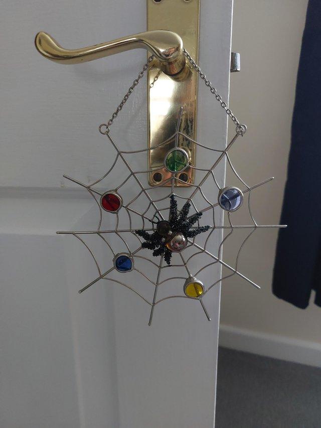 Preview of the first image of Hanging decoration of a spider in its Web.