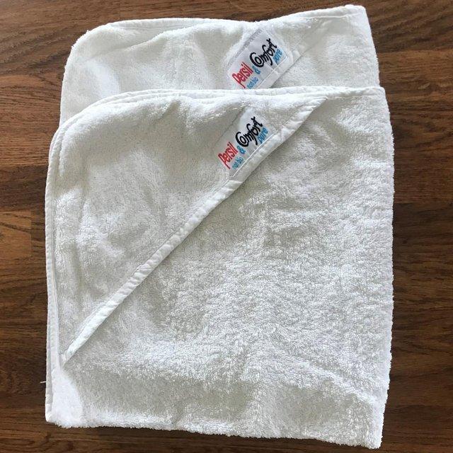 Preview of the first image of 2 hooded white cotton baby towels, Persil & Comfort.Can post.