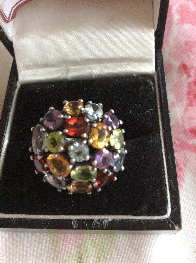 Preview of the first image of Large multi gem silver dress ring.