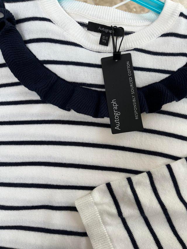Preview of the first image of Girls navy blue and white stripe jumper.