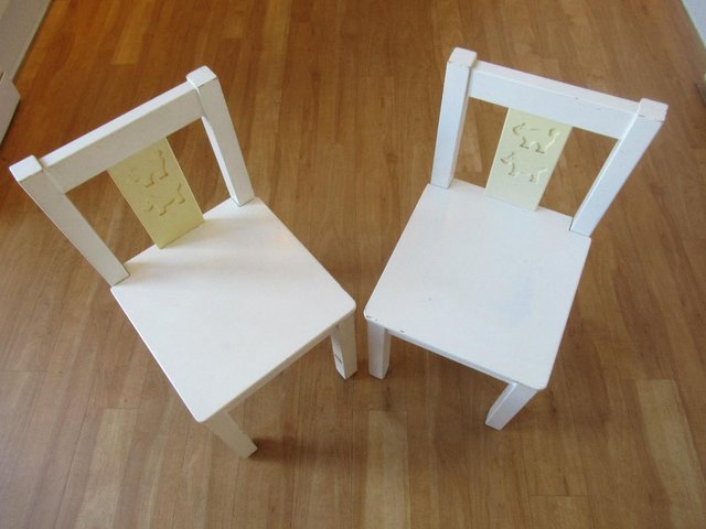 IKEA Two "Kritter" white wood child chairs.