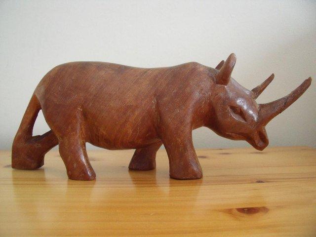 Preview of the first image of Vintage Besmo Products hand carved wood rhino from Kenya..