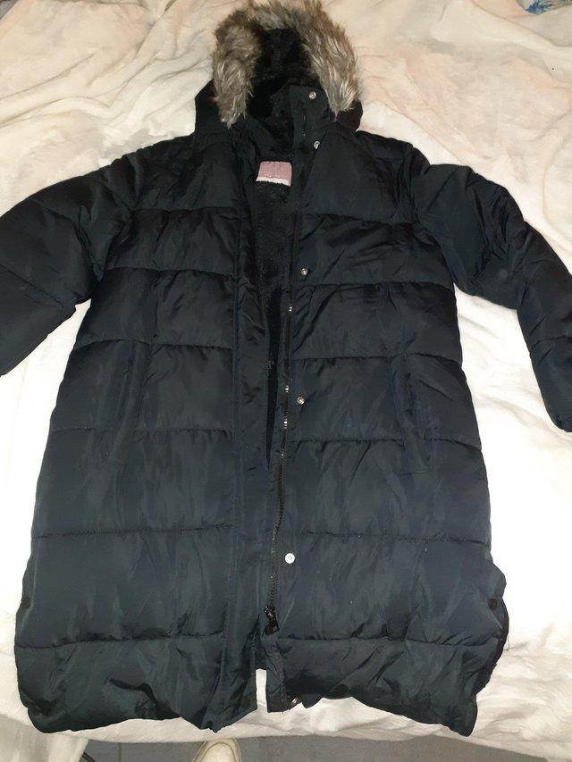 Preview of the first image of Girls age 13-14 long winter coat black. Brand new.