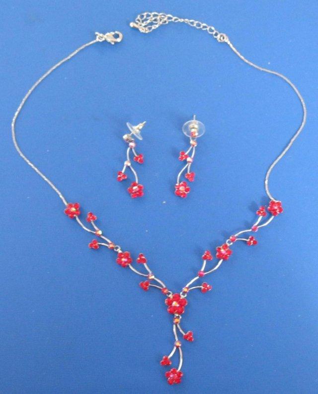 Preview of the first image of Red floral Necklace and earring set, new and unworn..