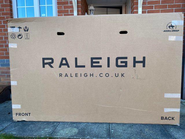 Preview of the first image of NEW Raleigh pink bike with full packaging.
