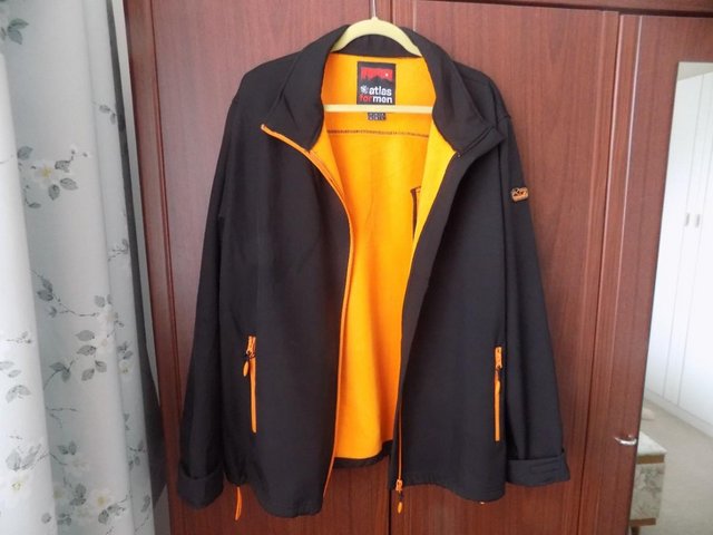 Preview of the first image of Men's casual jacket , black with orange lining.