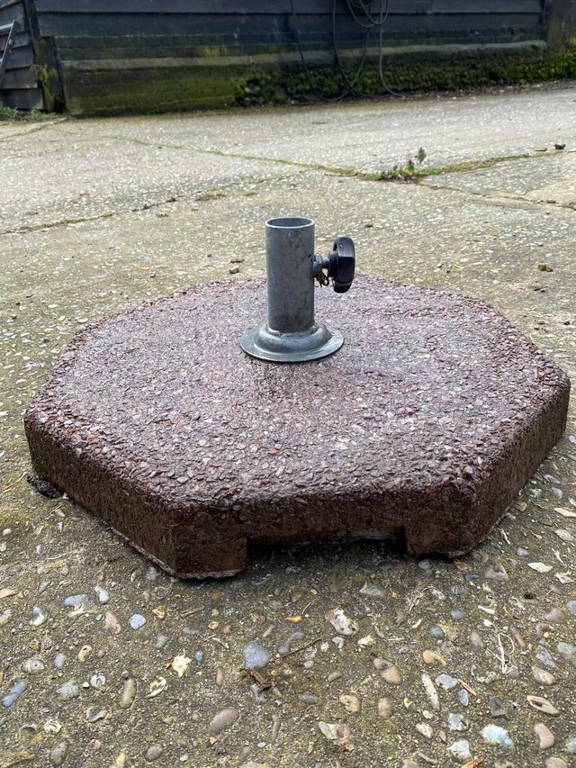 Preview of the first image of Sturdy stone parasol base 51cms wide.