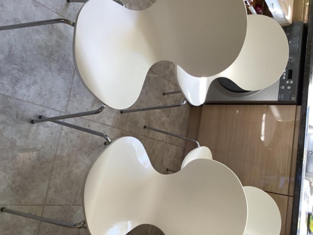 Preview of the first image of 4 white chairs with chrome legs.