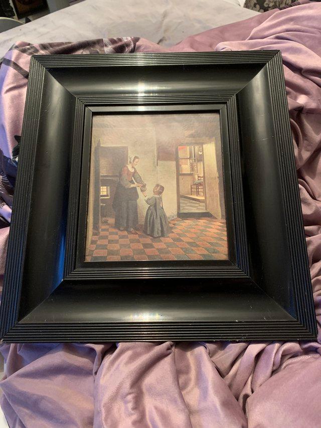 Preview of the first image of Print in black frame Lovely picture by pieter de hooch.