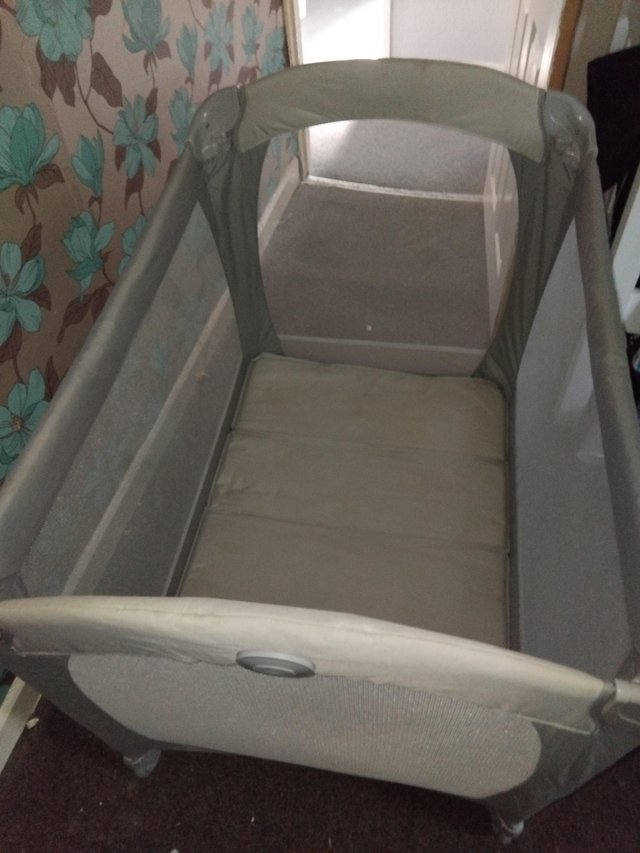 Preview of the first image of Travel cot with bassinet plus storage bag.