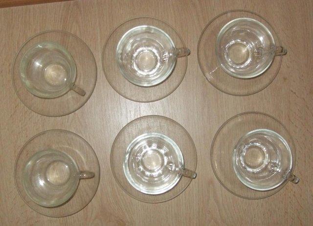 Preview of the first image of 6 small lightweight Pyrex Cups & Saucers.